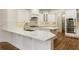 Modern kitchen with white cabinets, quartz counters and island at 6202 Talmadge Nw Way, Acworth, GA 30101