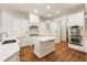 Modern kitchen with white cabinets, quartz counters and island at 6202 Talmadge Nw Way, Acworth, GA 30101