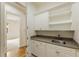 Laundry room with white cabinets, granite countertops, and a utility sink at 6202 Talmadge Nw Way, Acworth, GA 30101