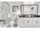 Well-lit bathroom with dual sinks, granite countertops, and a glass-enclosed shower at 3621 Vinings Slope Se # 1537, Atlanta, GA 30339