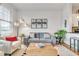 Bright living room featuring a gray sofa and wood coffee table at 3621 Vinings Slope Se # 1537, Atlanta, GA 30339