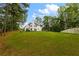 Large backyard with a view of the house and surrounding trees at 3545 Silver Vista Ct, Cumming, GA 30041