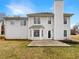 Backyard view of home featuring spacious lawn, concrete patio, and bay window at 1615 Cheshire Ct, Lawrenceville, GA 30043