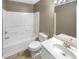 Bathroom features a tub/shower combo, toilet, sink and vanity at 1615 Cheshire Ct, Lawrenceville, GA 30043