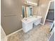 Bright bathroom featuring a double vanity with white cabinets and neutral toned flooring at 1615 Cheshire Ct, Lawrenceville, GA 30043