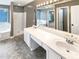 Gray bathroom with double vanity, bath tub, shower, and large mirror at 1615 Cheshire Ct, Lawrenceville, GA 30043