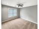 This carpeted bedroom has a large window and recessed lighting and neutral paint at 1615 Cheshire Ct, Lawrenceville, GA 30043