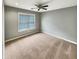 This spacious bedroom features new carpet, neutral gray paint, and a bright window with natural light at 1615 Cheshire Ct, Lawrenceville, GA 30043