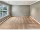 This bedroom offers plush carpeting, neutral gray wall paint, bright light, and a large window at 1615 Cheshire Ct, Lawrenceville, GA 30043