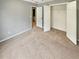 Cozy bedroom with neutral carpet, closet, and adjoining room at 1615 Cheshire Ct, Lawrenceville, GA 30043