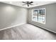 Bedroom features a ceiling fan, a large window, neutral carpet and walls at 1615 Cheshire Ct, Lawrenceville, GA 30043
