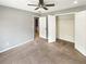 Bedroom features neutral carpet and walls, closet and access to en-suite bathroom at 1615 Cheshire Ct, Lawrenceville, GA 30043