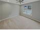 Bright bedroom featuring a ceiling fan and large window with a view of the neighborhood at 1615 Cheshire Ct, Lawrenceville, GA 30043