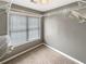 Cozy closet space with window, built-in shelving units and tan carpeting at 1615 Cheshire Ct, Lawrenceville, GA 30043