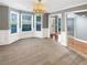 Elegant dining room with carpet flooring, wainscoting, and a large bay window for ample natural light at 1615 Cheshire Ct, Lawrenceville, GA 30043