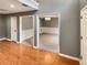 Open foyer with high ceilings, hardwood floors, gray walls, white trim, and a view into the dining room at 1615 Cheshire Ct, Lawrenceville, GA 30043