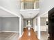 Spacious foyer with hardwood floors leads to various rooms, showcasing neutral walls and high ceilings at 1615 Cheshire Ct, Lawrenceville, GA 30043