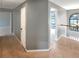 Upstairs hallway features carpet, doors, natural light, and neutral paint at 1615 Cheshire Ct, Lawrenceville, GA 30043