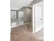 Upstairs hallway features neutral paint and carpet, with a door leading to another room at 1615 Cheshire Ct, Lawrenceville, GA 30043