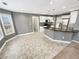 Bright kitchen features white cabinetry, stainless appliances, and a peninsula with breakfast bar at 1615 Cheshire Ct, Lawrenceville, GA 30043