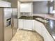 Modern kitchen with stainless steel refrigerator, granite countertops, and white cabinetry at 1615 Cheshire Ct, Lawrenceville, GA 30043