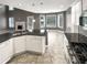 Open-concept kitchen boasts granite counters, stainless appliances, white cabinets, and views of the living area at 1615 Cheshire Ct, Lawrenceville, GA 30043