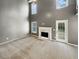 Living room featuring fireplace, ceiling fan, high ceilings, and a glass panel exterior door at 1615 Cheshire Ct, Lawrenceville, GA 30043