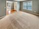 Open-concept living room featuring wood floors, carpet, a bright window, and fresh gray paint at 1615 Cheshire Ct, Lawrenceville, GA 30043