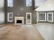 Bright living room boasts fireplace, large windows, neutral walls, and plush carpeting at 1615 Cheshire Ct, Lawrenceville, GA 30043