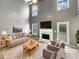 A living room with high ceilings, a marble fireplace, and neutral decor at 1615 Cheshire Ct, Lawrenceville, GA 30043