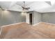 Main bedroom features tray ceiling, fan, neutral paint, carpet, and access to en-suite bathroom at 1615 Cheshire Ct, Lawrenceville, GA 30043