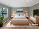 A staged main bedroom with neutral tones, natural light, and minimalist furniture at 1615 Cheshire Ct, Lawrenceville, GA 30043