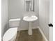 A powder room offers a pedestal sink and toilet, featuring gray walls and modern fixtures in a compact space at 1615 Cheshire Ct, Lawrenceville, GA 30043