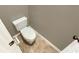 This half bathroom features a standard toilet, and light beige colored walls at 1615 Cheshire Ct, Lawrenceville, GA 30043