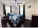 Inviting bedroom featuring a comfortable bed, dark wood floors, and natural light from the windows at 2161 Penelope Nw St, Atlanta, GA 30314