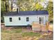 Rear view of a home with a small deck and backyard, showcasing the siding and roof at 2161 Penelope Nw St, Atlanta, GA 30314