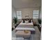 Inviting bedroom with neutral tones, a plush bed, and decorative plants at 958 Fellowship Rd, Fairburn, GA 30213