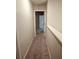 Carpeted hallway with a view of a bedroom through an open doorway at 958 Fellowship Rd, Fairburn, GA 30213