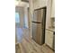 Kitchen with stainless steel refrigerator, granite countertops and luxury vinyl plank flooring at 958 Fellowship Rd, Fairburn, GA 30213