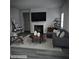 Cozy living room featuring a fireplace, sleek gray furniture, and elegant decor at 958 Fellowship Rd, Fairburn, GA 30213