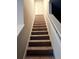 Carpeted staircase leading upwards, with white railings and neutral walls at 958 Fellowship Rd, Fairburn, GA 30213