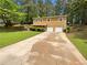 Two-story home featuring a lengthy driveway and an attached two-car garage surrounded by lush trees at 5942 Rock Court #5, Union City, GA 30291