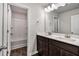 Bathroom with double sink vanity, wooden cabinets, and marble countertops at 3270 Forest Green Dr, Douglasville, GA 30135