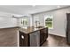 Kitchen island featuring granite countertops, stainless steel appliances, and dark wood cabinets at 3270 Forest Green Dr, Douglasville, GA 30135