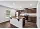 Modern kitchen featuring an island with granite countertops, stainless steel appliances, and wood cabinets at 3270 Forest Green Dr, Douglasville, GA 30135