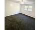 This is a bedroom with carpet and a window to let in natural light at 1177 Church St # F, Decatur, GA 30030
