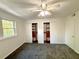 Bright bedroom featuring neutral carpet, large window, ceiling fan, and closets at 1177 Church St # F, Decatur, GA 30030