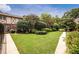 View of the shared greenspace with mature landscaping and manicured lawn at 1177 Church St # F, Decatur, GA 30030
