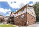 Exterior of brick condo building showing multiple units, stairs and parking area at 1177 Church St # F, Decatur, GA 30030