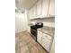 A compact kitchen featuring white cabinets, granite countertops, and stainless steel appliances at 1177 Church St # F, Decatur, GA 30030